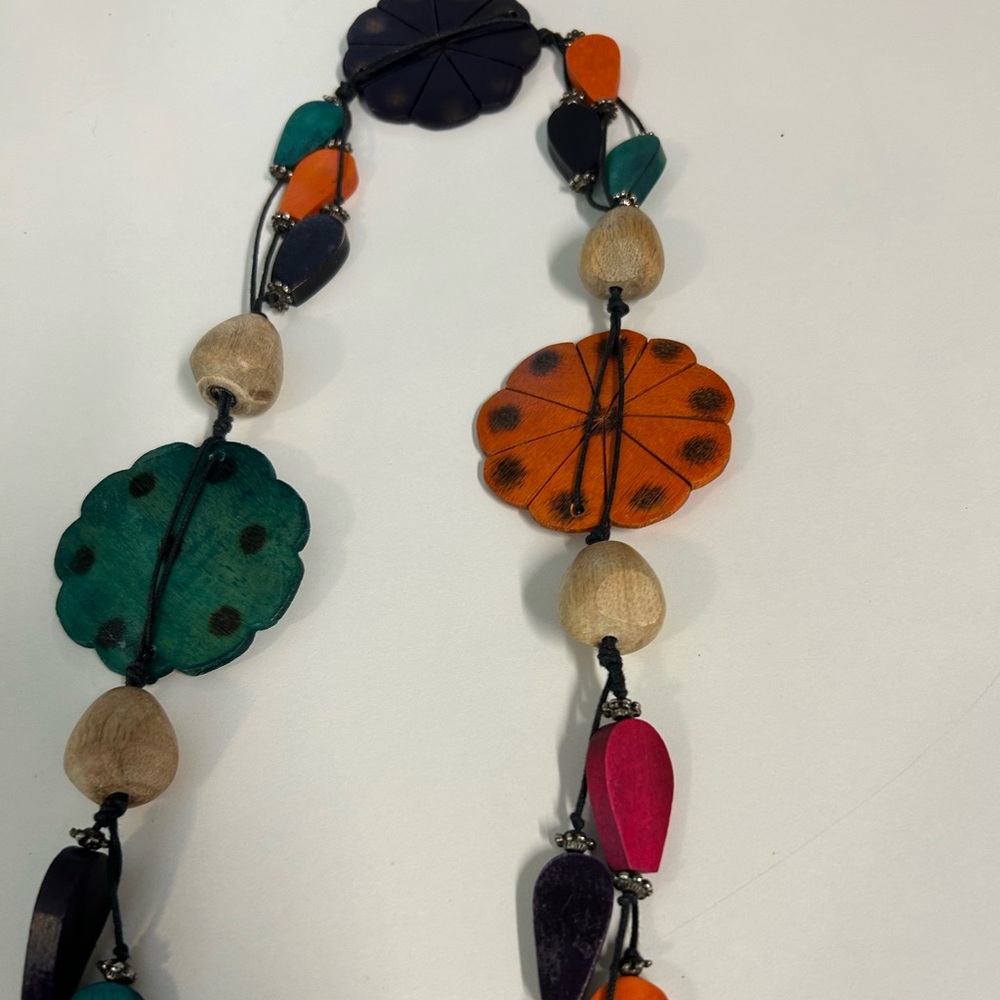 Whimsical belt or necklace with multicolored wooden designs.